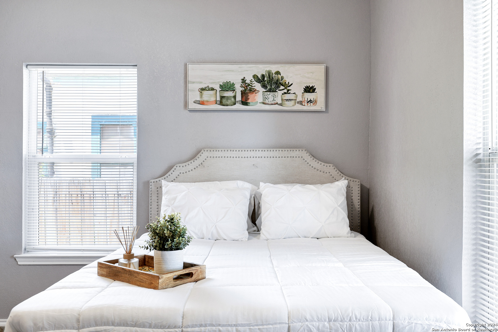 a bed sitting in a bedroom next to a window