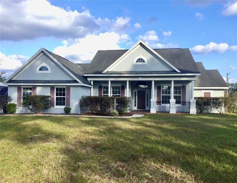 a front view of a house with a yard and porch