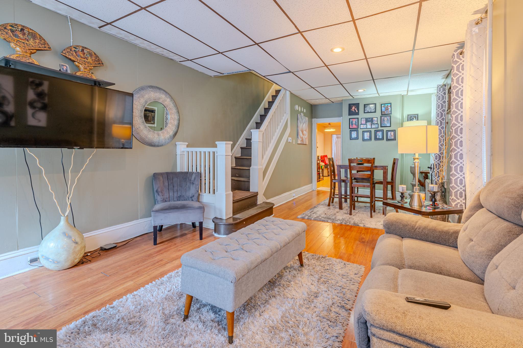 a living room with patio furniture and a wooden floor