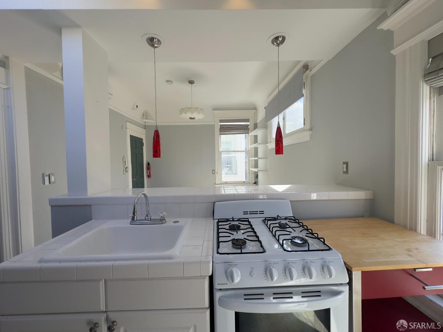 a kitchen with a stove a sink and a refrigerator