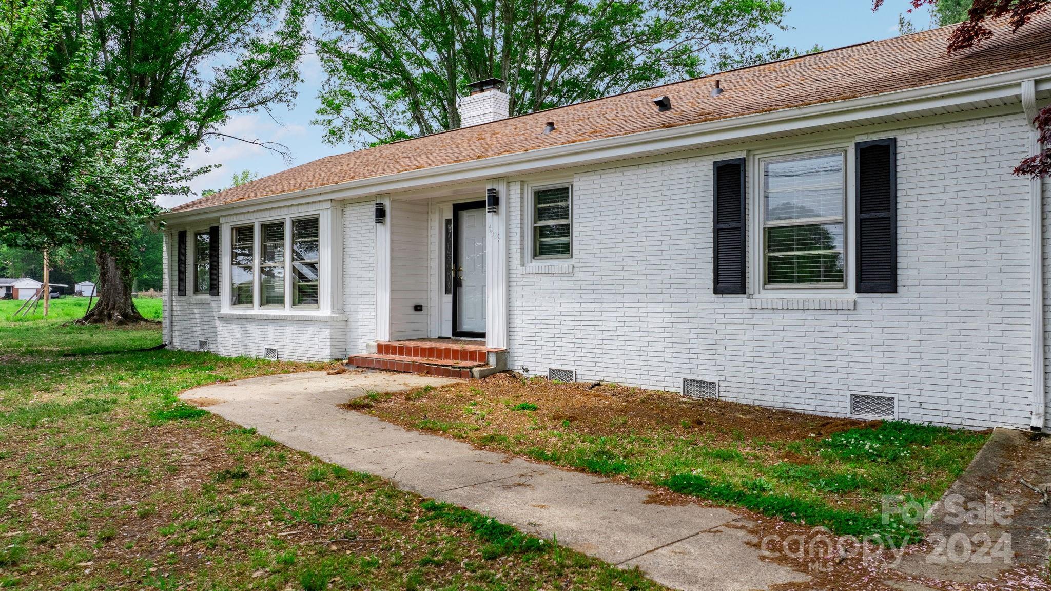 a front view of a house with a yard and porch