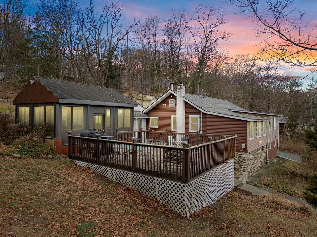 Back house at dusk with a deck