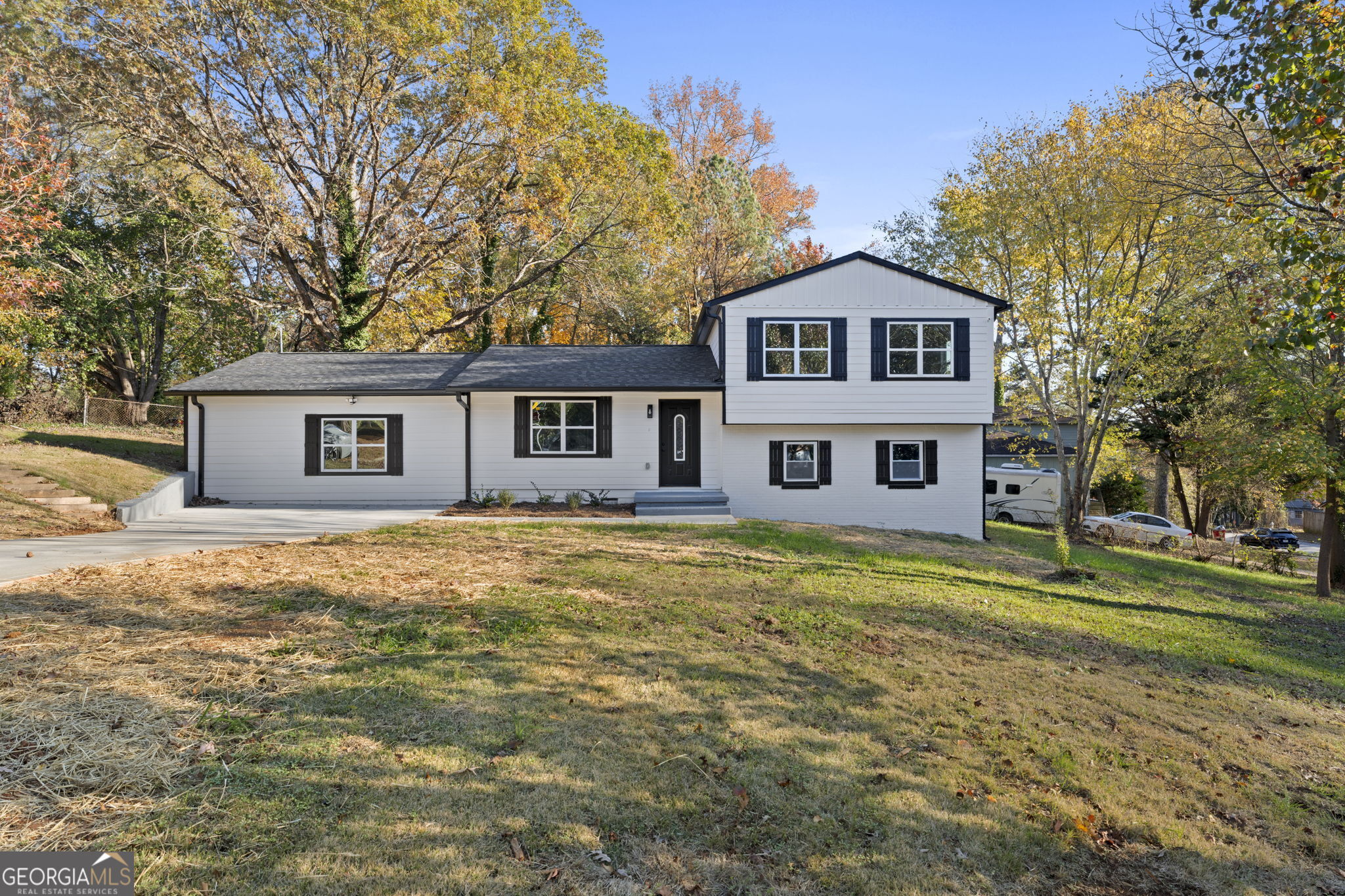 a front view of a house with a garden