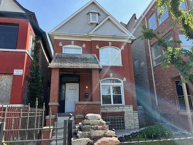 a front view of a house with a garden