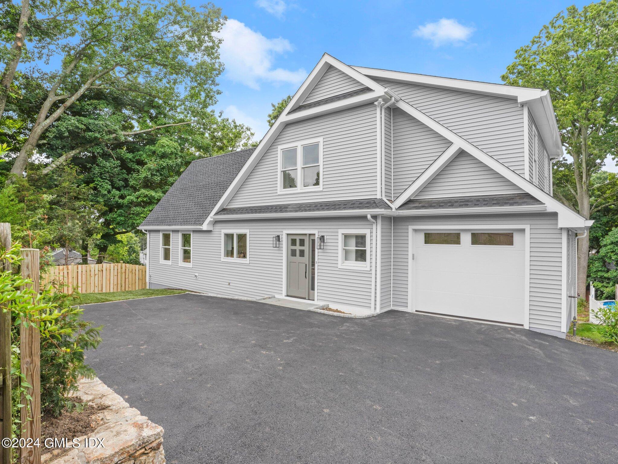 a view of a house with a yard and garage