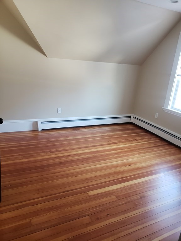 a view of a room with wooden floor and white walls