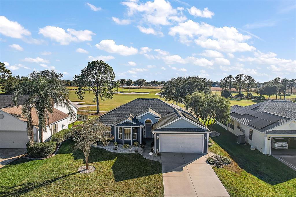 an aerial view of a house with a ocean view