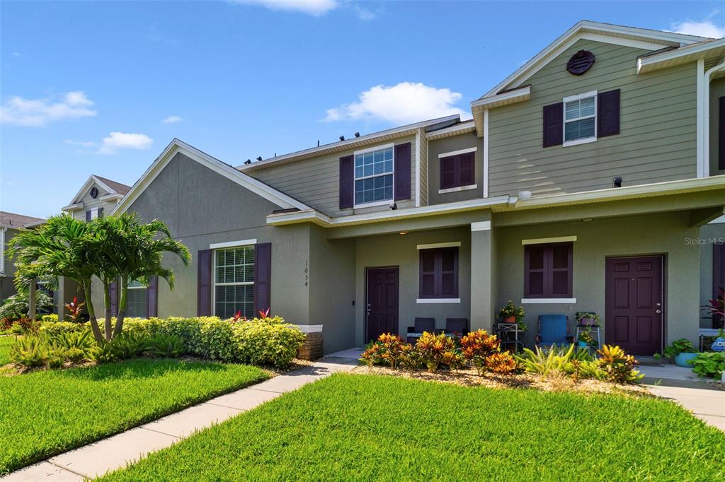 a front view of a house with garden