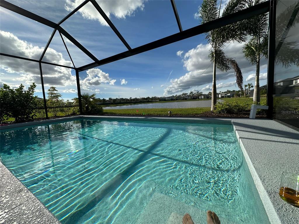 a view of swimming pool with a yard