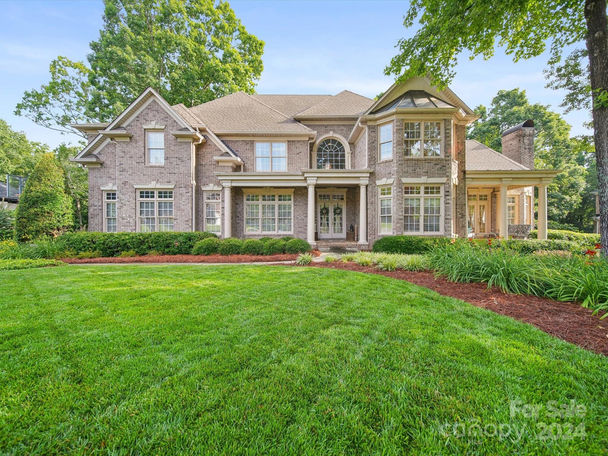 a front view of a house with a garden