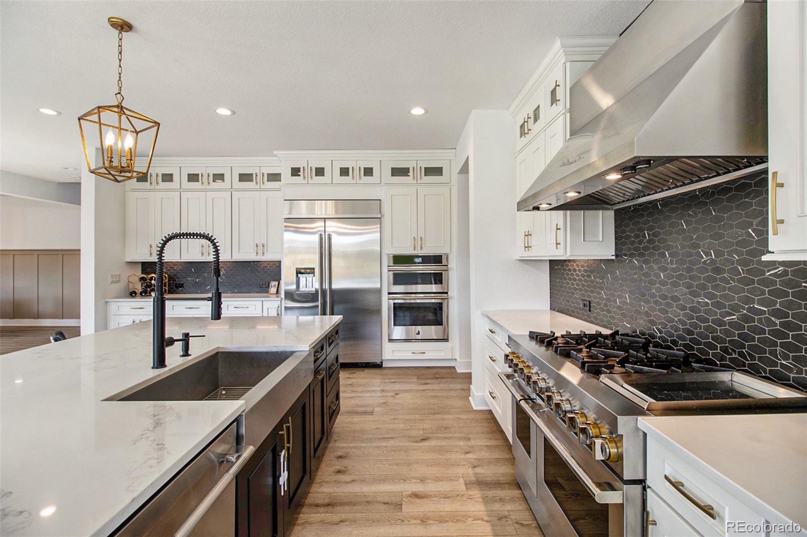 a kitchen with stainless steel appliances granite countertop a sink stove and refrigerator