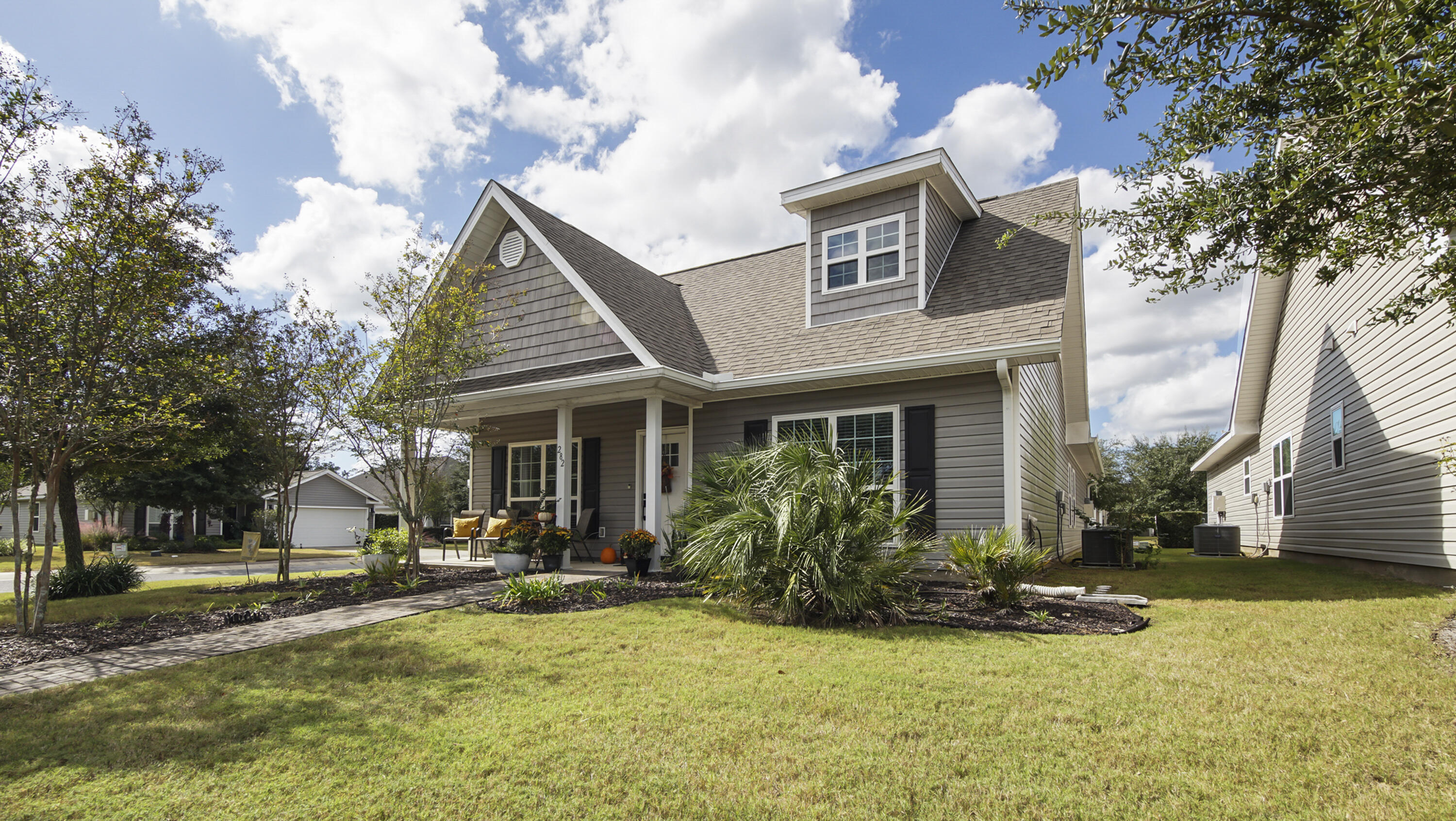 a view of a house with yard and tree s