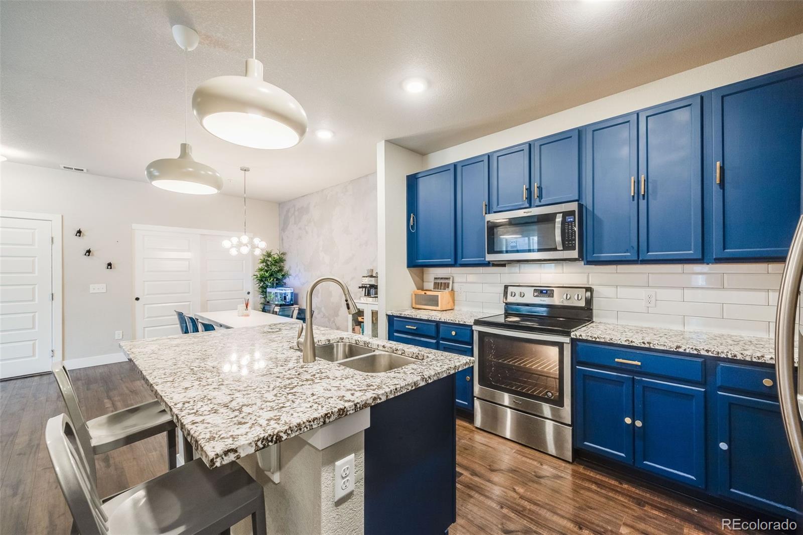 a kitchen with granite countertop stainless steel appliances and wooden cabinets