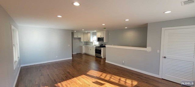 a view of a kitchen with wooden floor