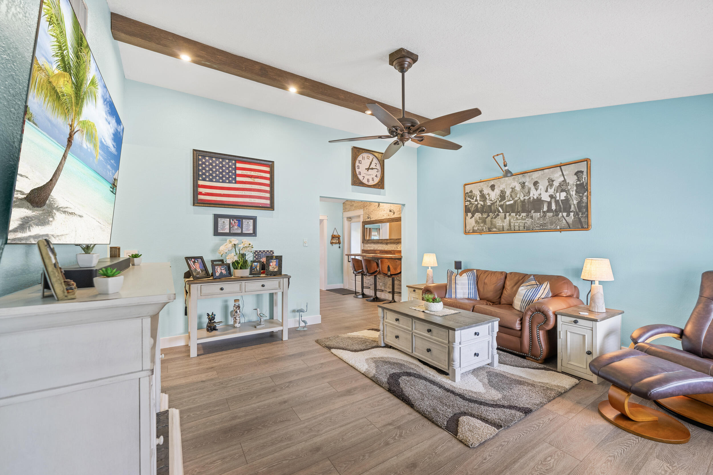 a living room with furniture and a wooden floor