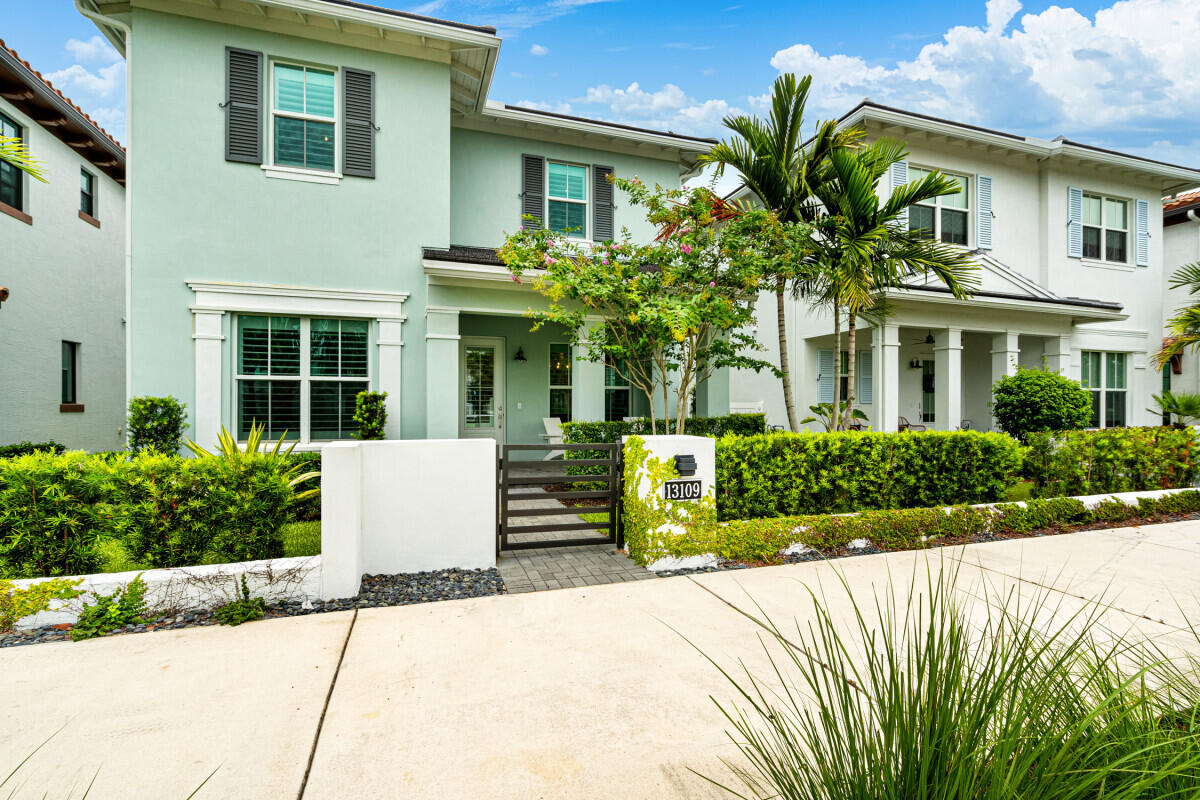 a front view of a house with a garden