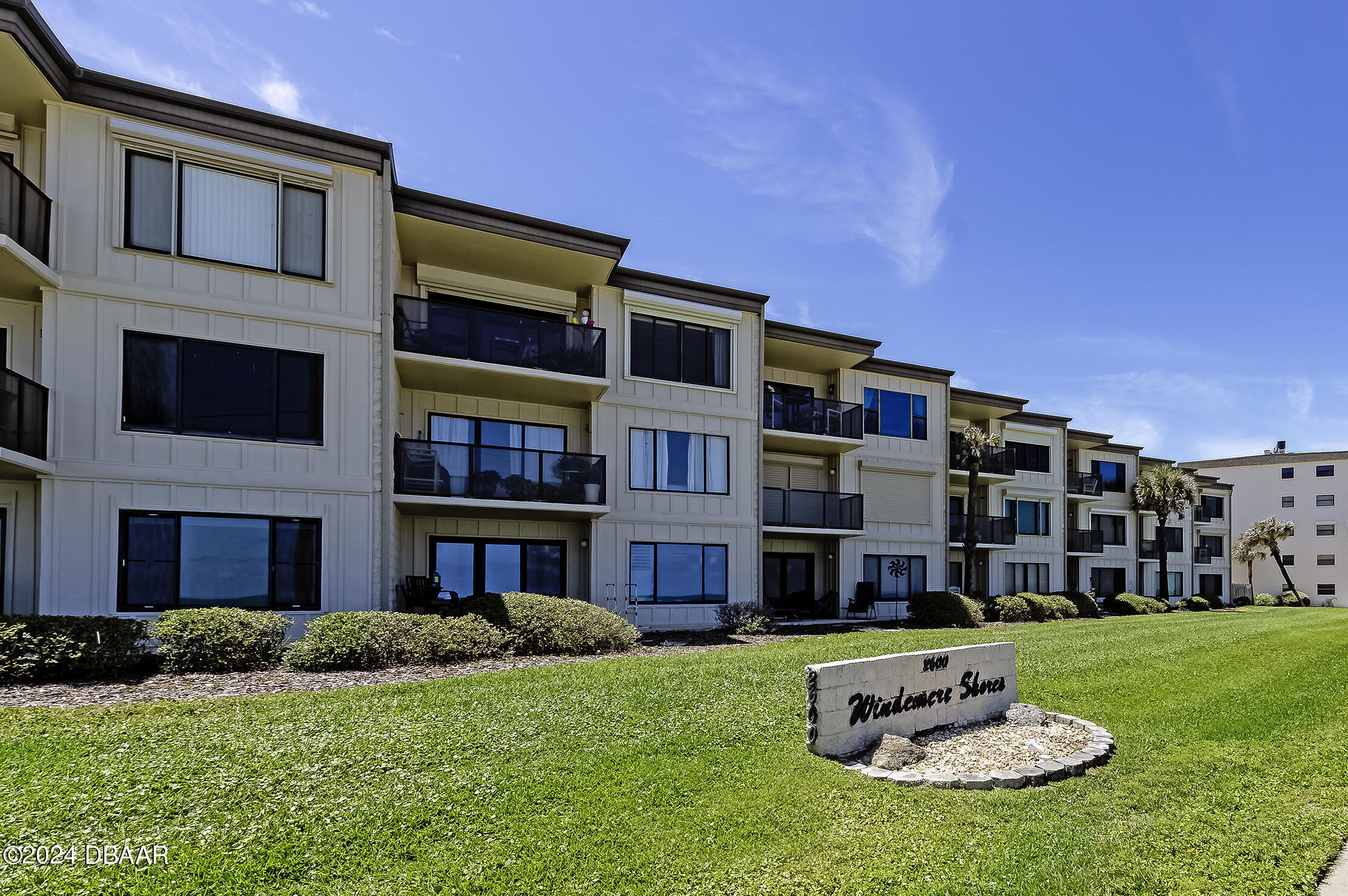 a front view of a building with a yard