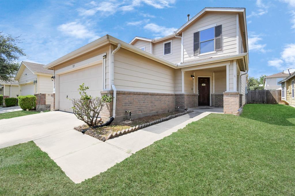 a front view of a house with a yard and garage