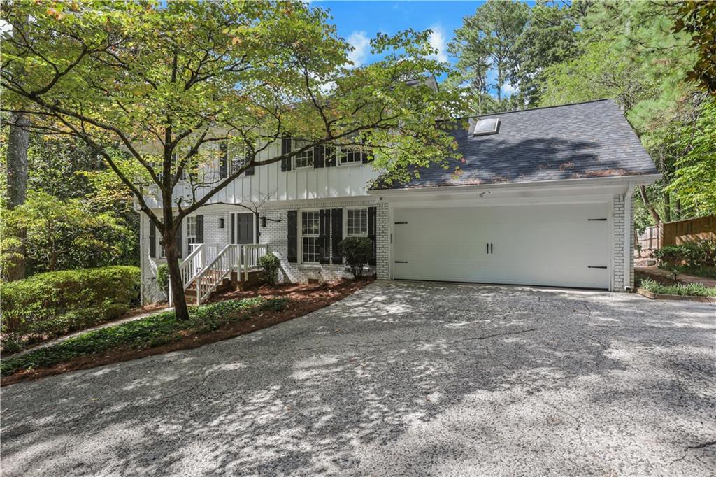 a view of a house with a yard and garage