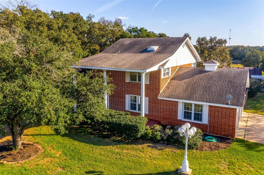 a aerial view of a house with yard and sitting area