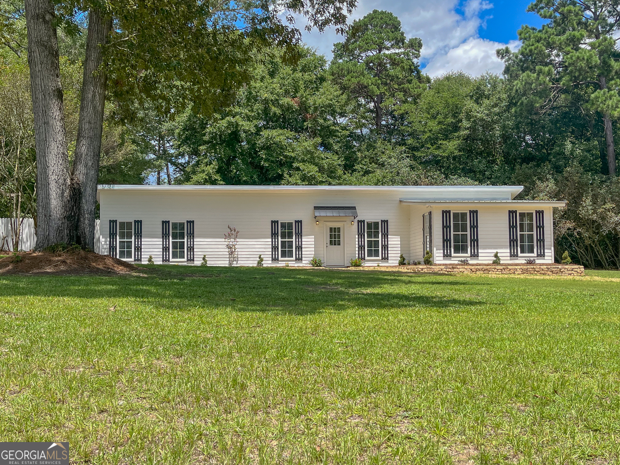 a view of a house with a backyard