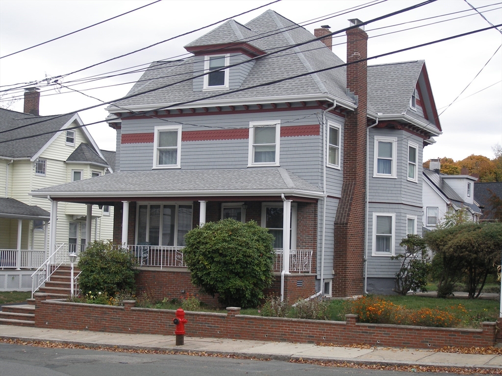 a view of a brick house with a yard