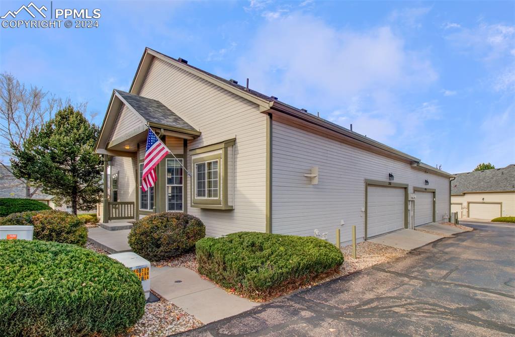 View of property exterior with a garage