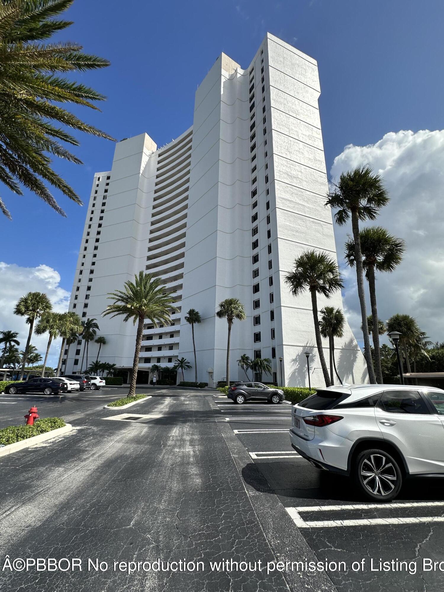 a view of a building with car parked