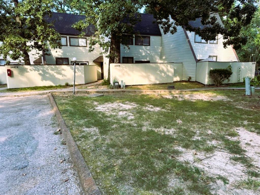 a view of a house with yard and sitting area