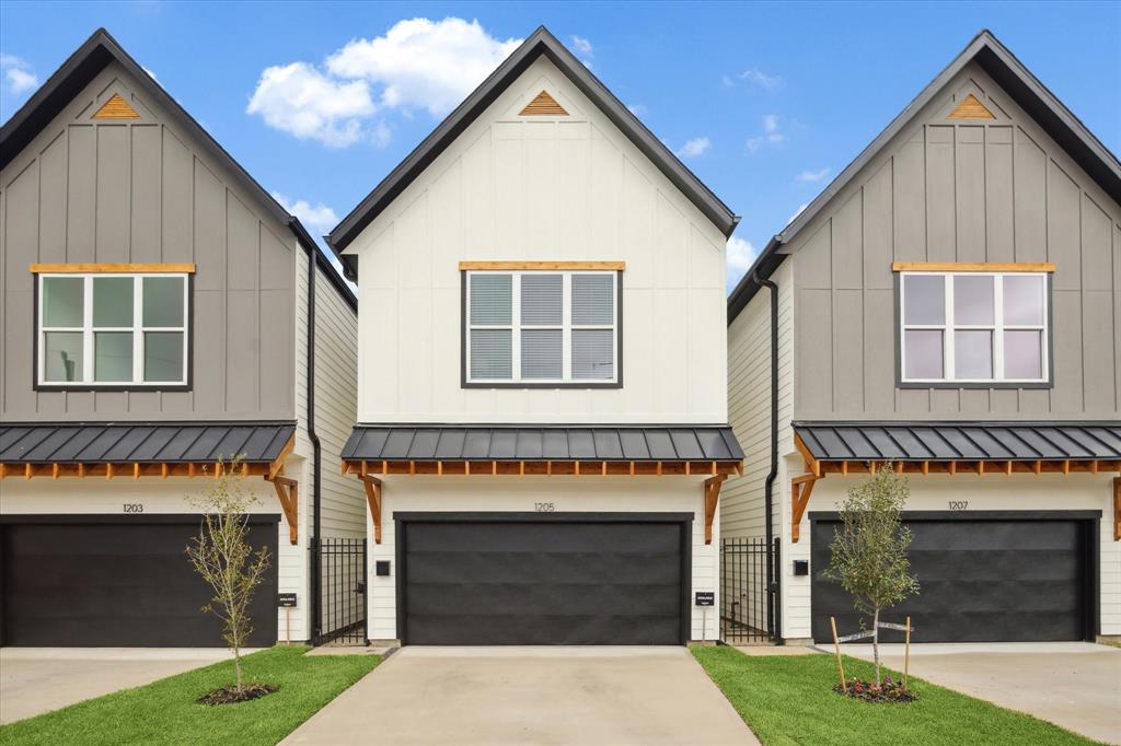 With a perfect balance of traditional and contemporary design, this 2-story farmhouse blends durable hardie sidding with lightly-stained treated wood.