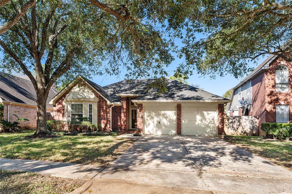 This red brick one story welcomes you with a wide driveway.