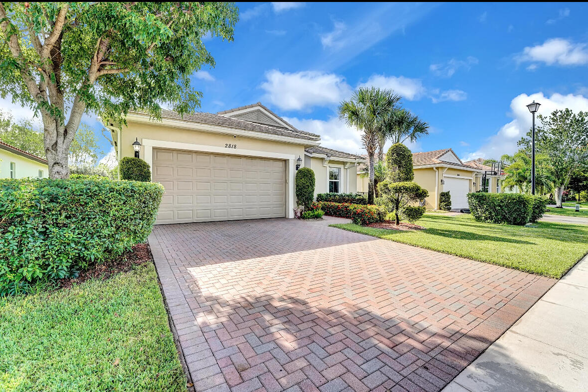 a front view of a house with a yard and a garage