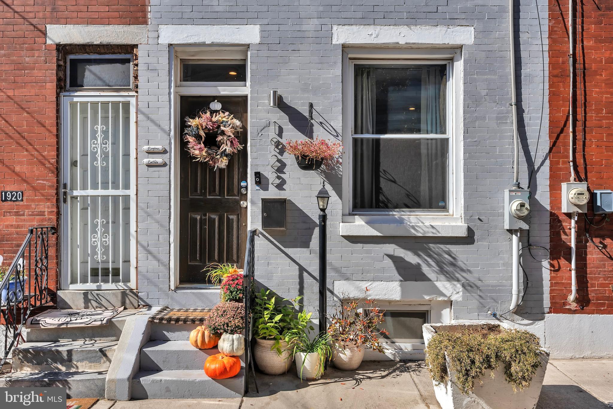 a view of a house with potted plants