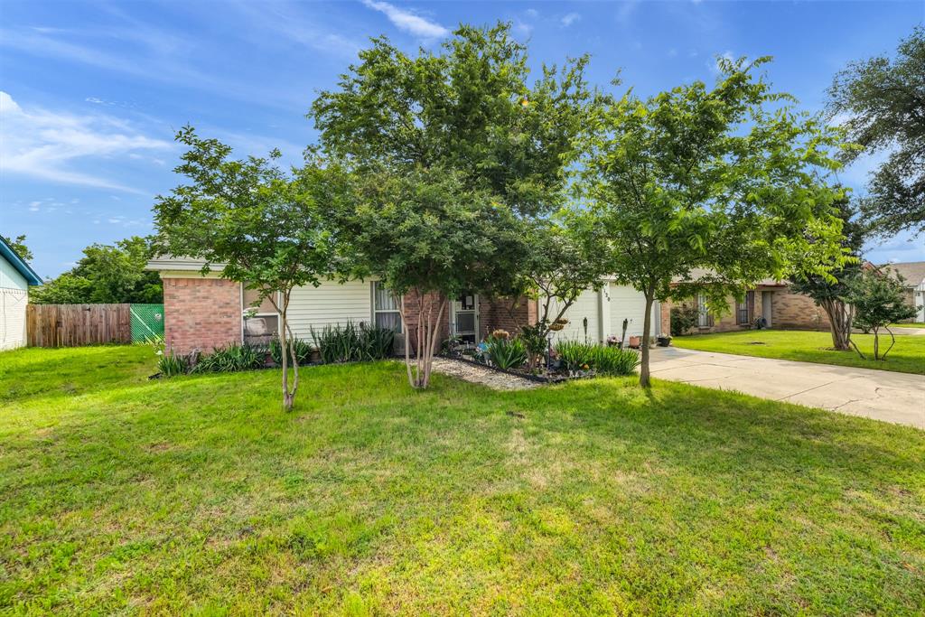 a view of a house with a backyard