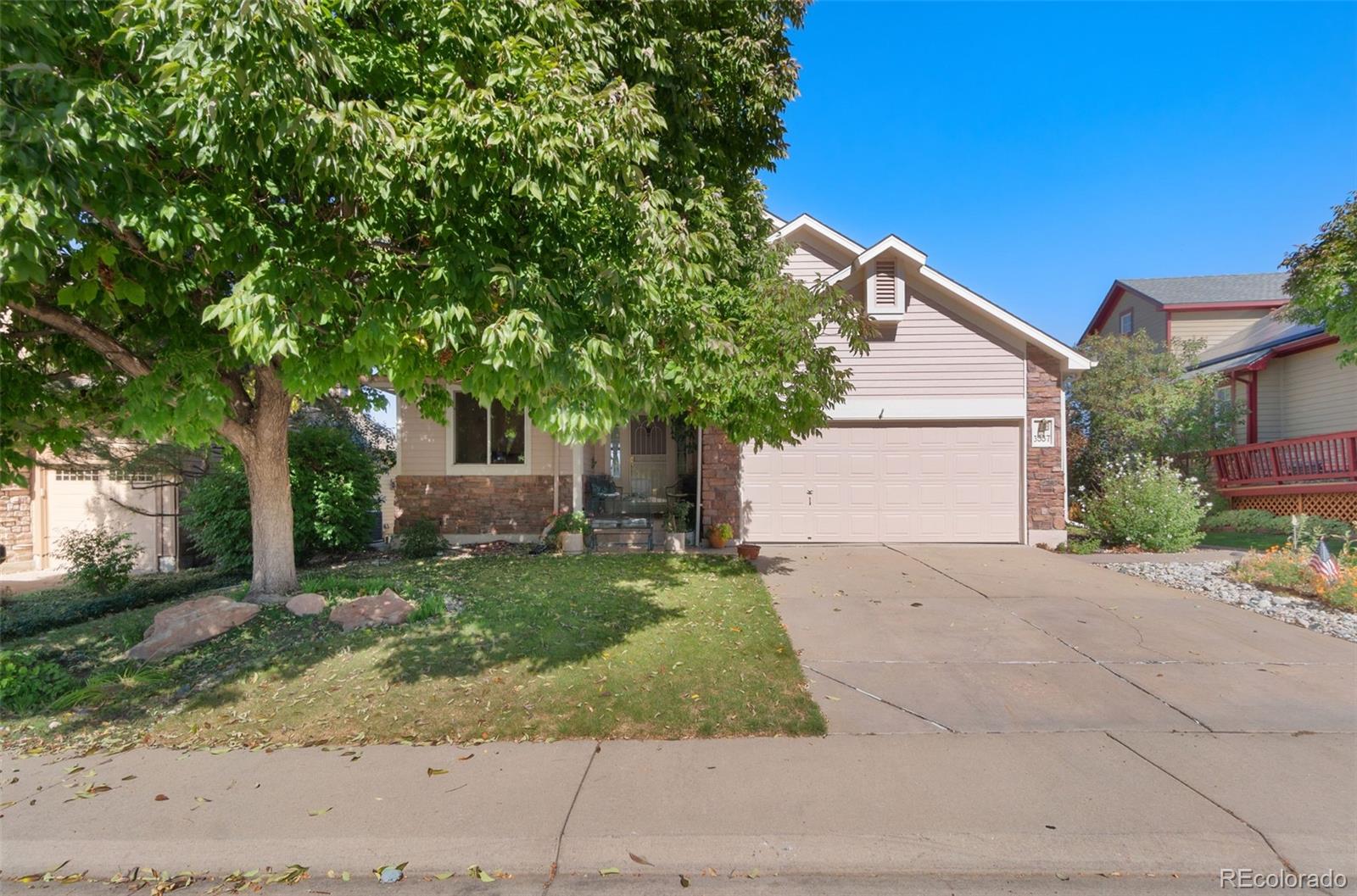 a front view of a house with a yard and garage