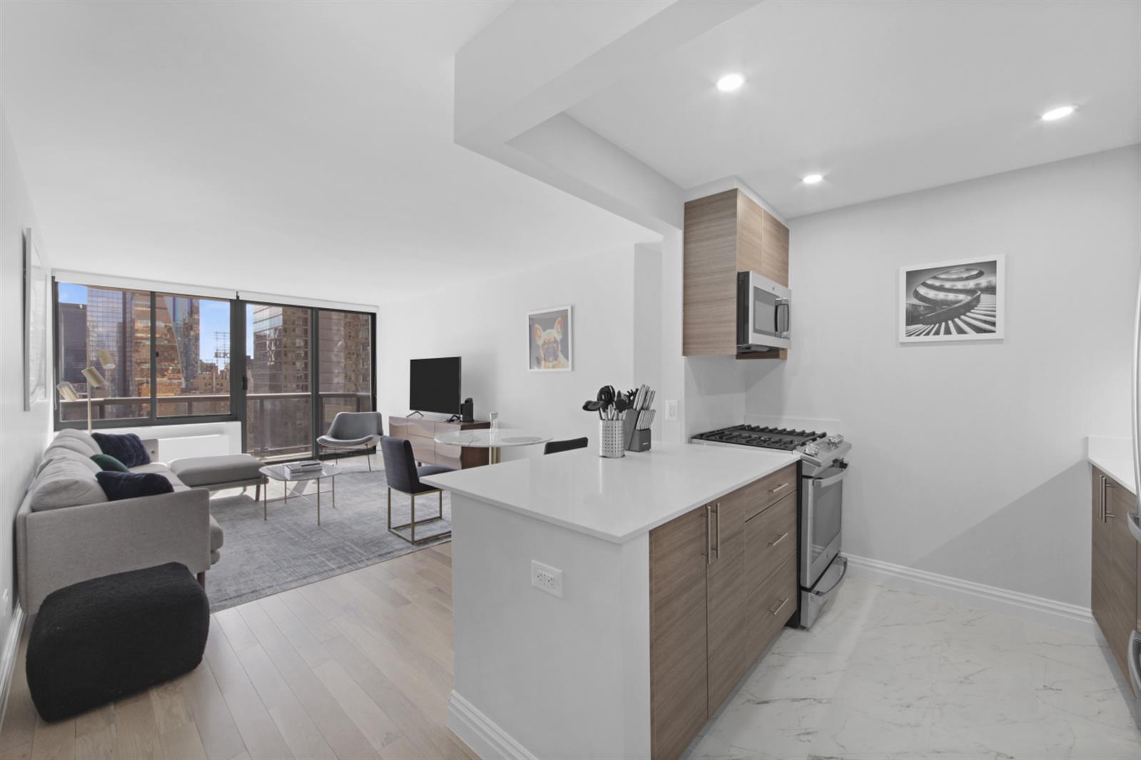 a view of living room filled with furniture and large window