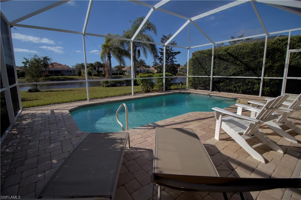 a view of a patio with table and chairs under an umbrella