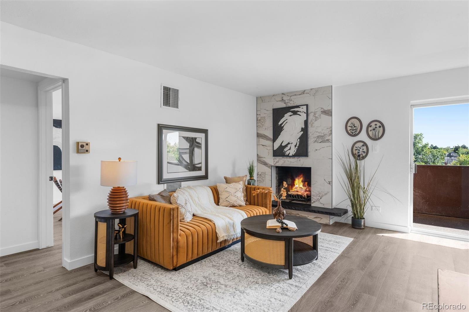 a living room with furniture and a fireplace