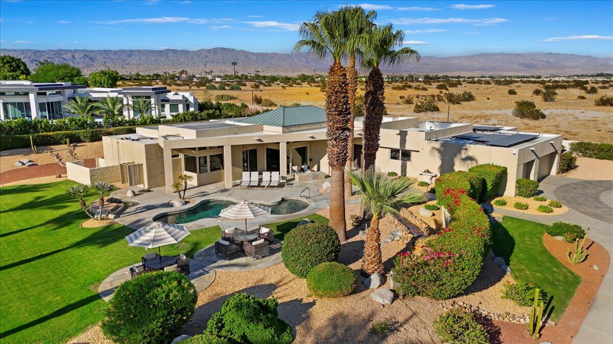 an aerial view of residential houses with outdoor space and trees all around