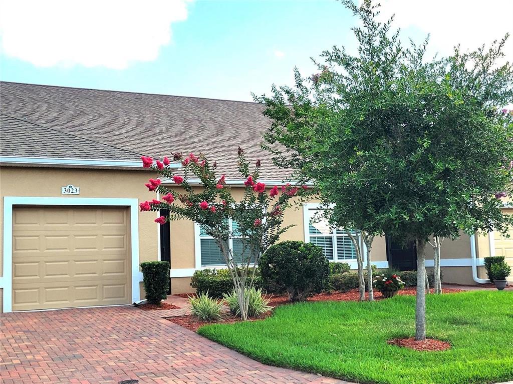 a front view of a house with a yard and a garage