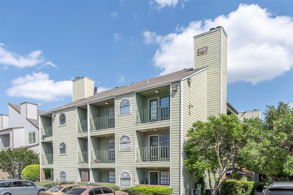 a front view of a residential apartment building with a yard