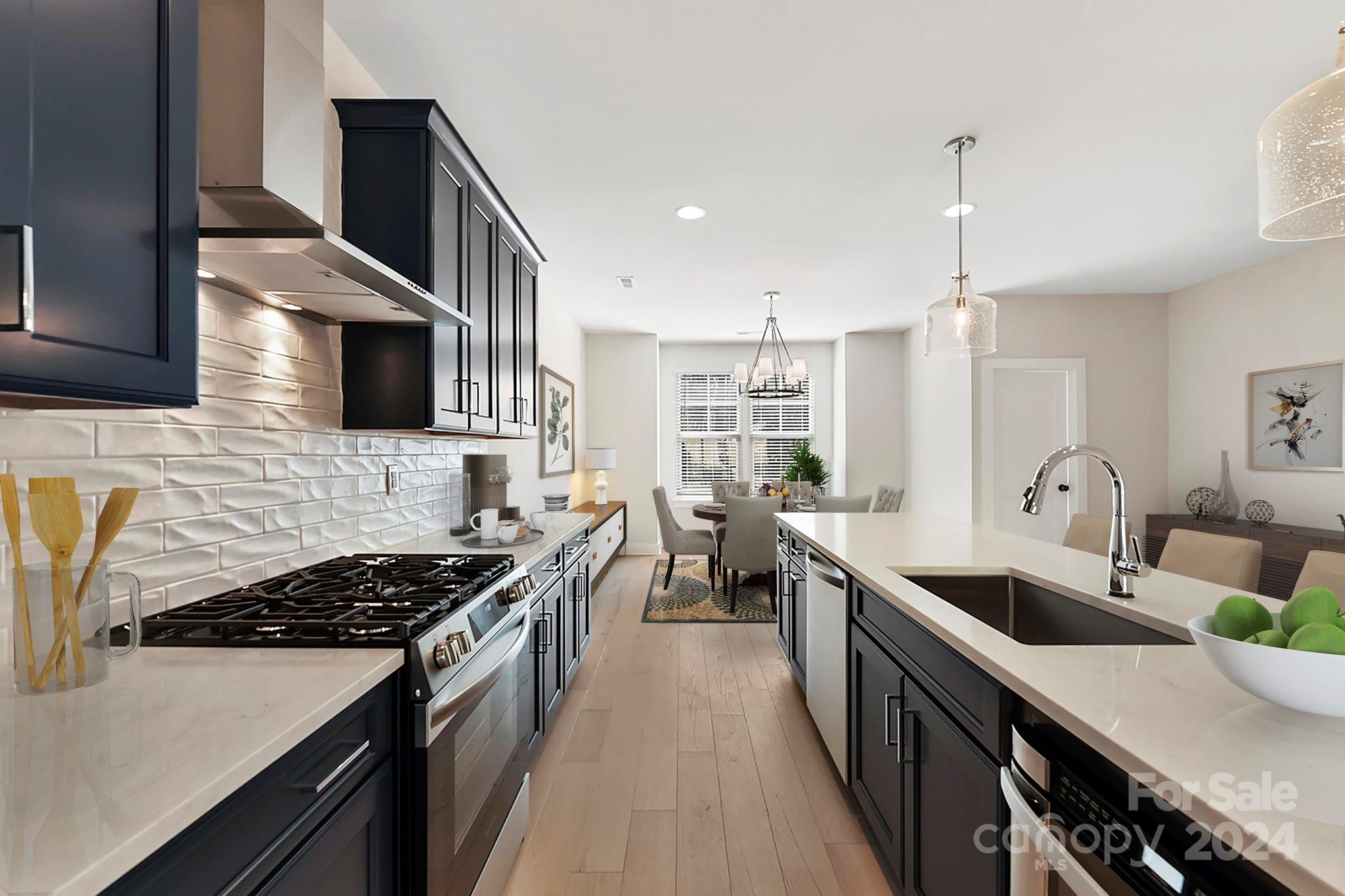 a kitchen with granite countertop a sink stove and cabinets