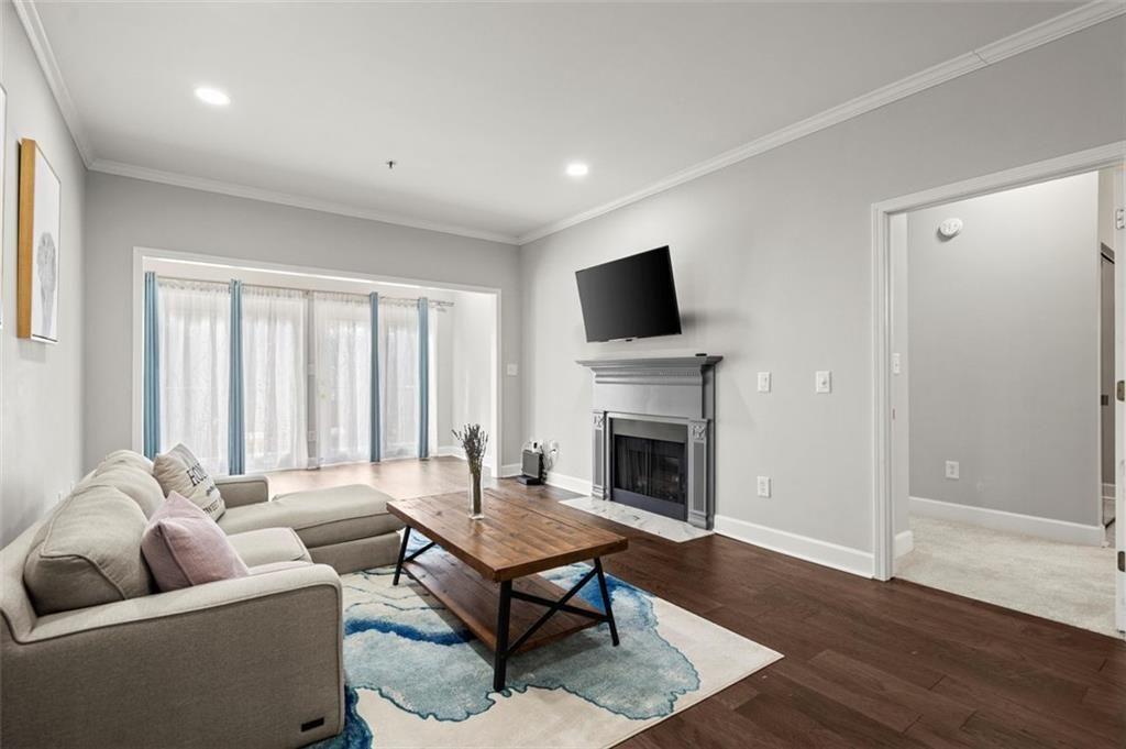 a living room with furniture a fireplace and a flat screen tv