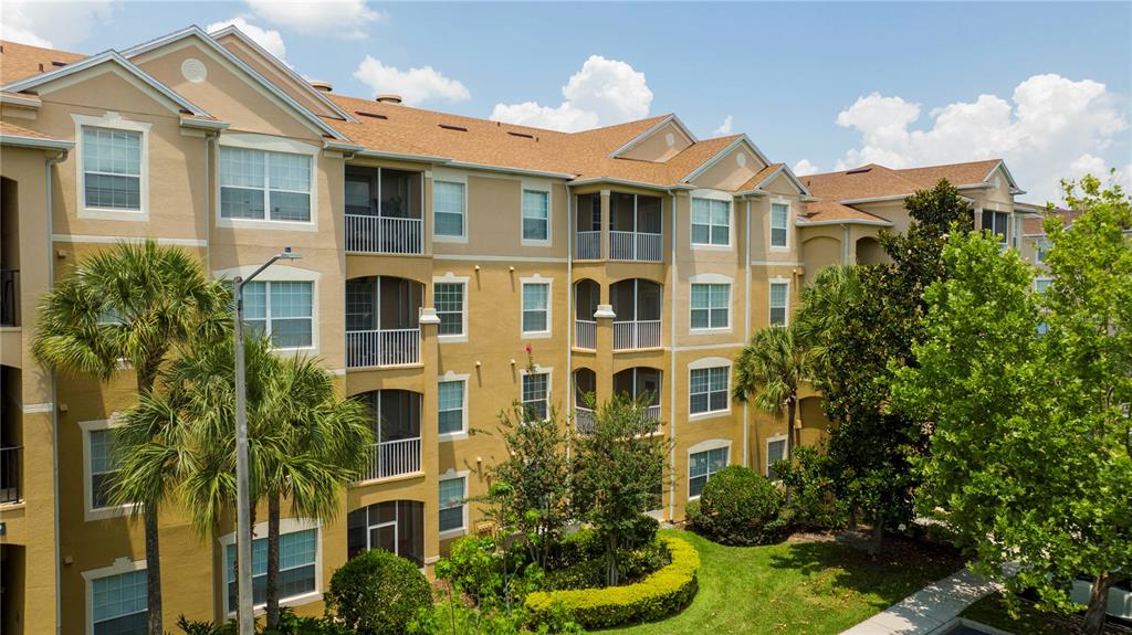 a front view of a residential apartment building with a yard