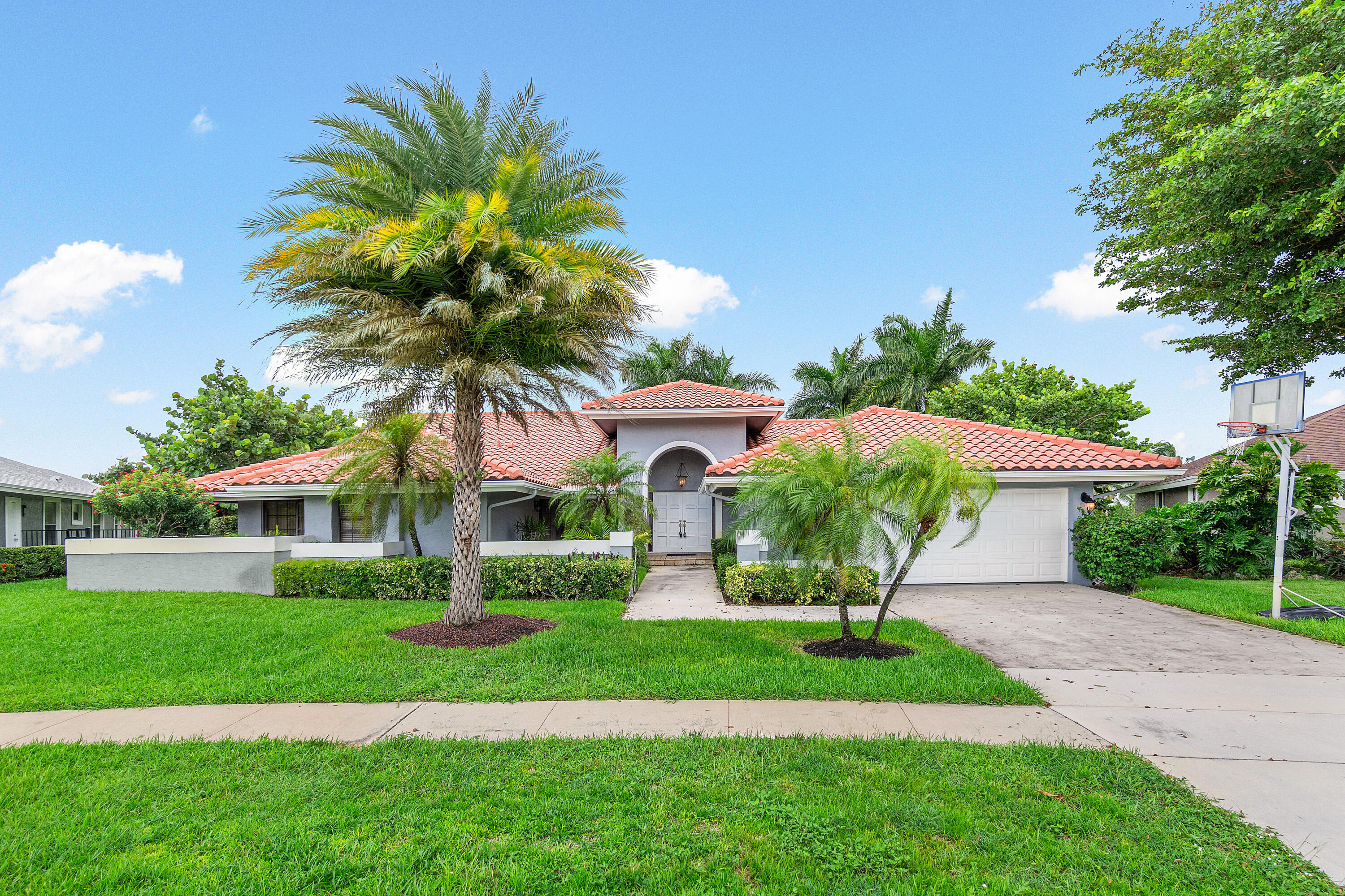 a front view of house with yard and green space