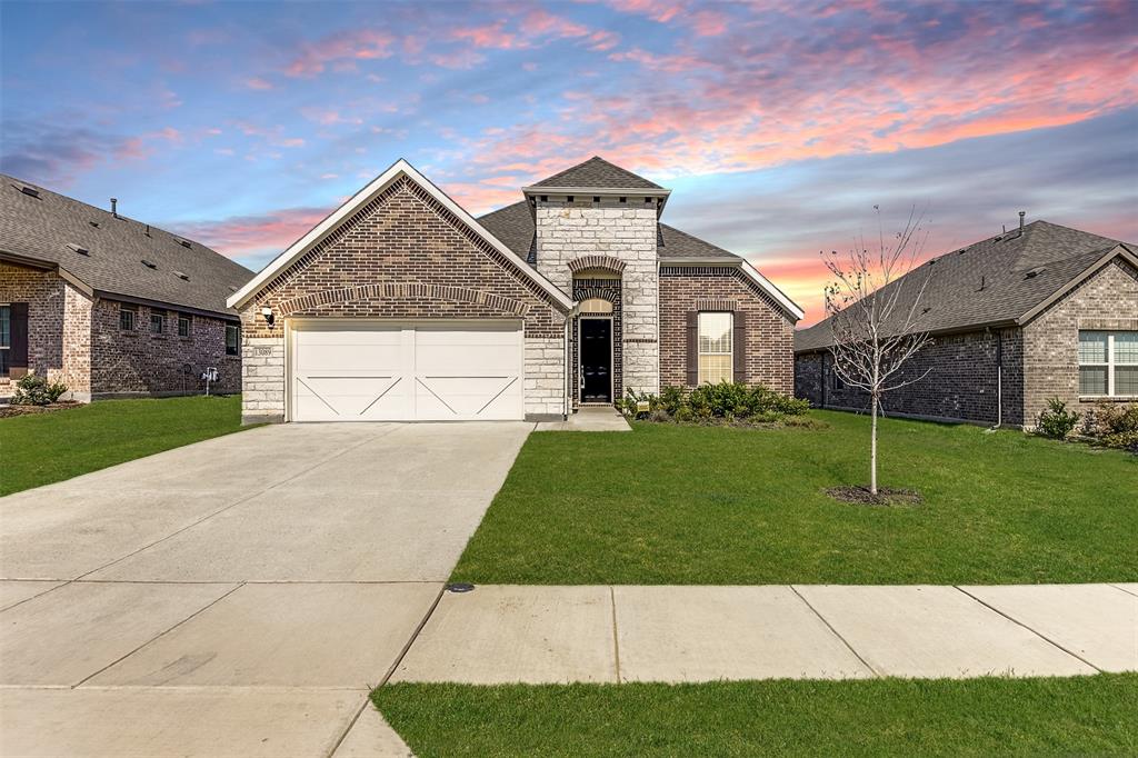 a view of a brick house with a yard