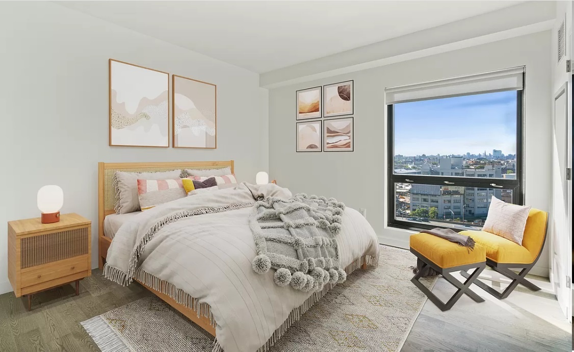 a bedroom with bed and glass window