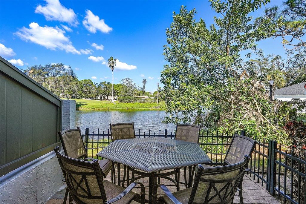 a view of a balcony with furniture and a garden