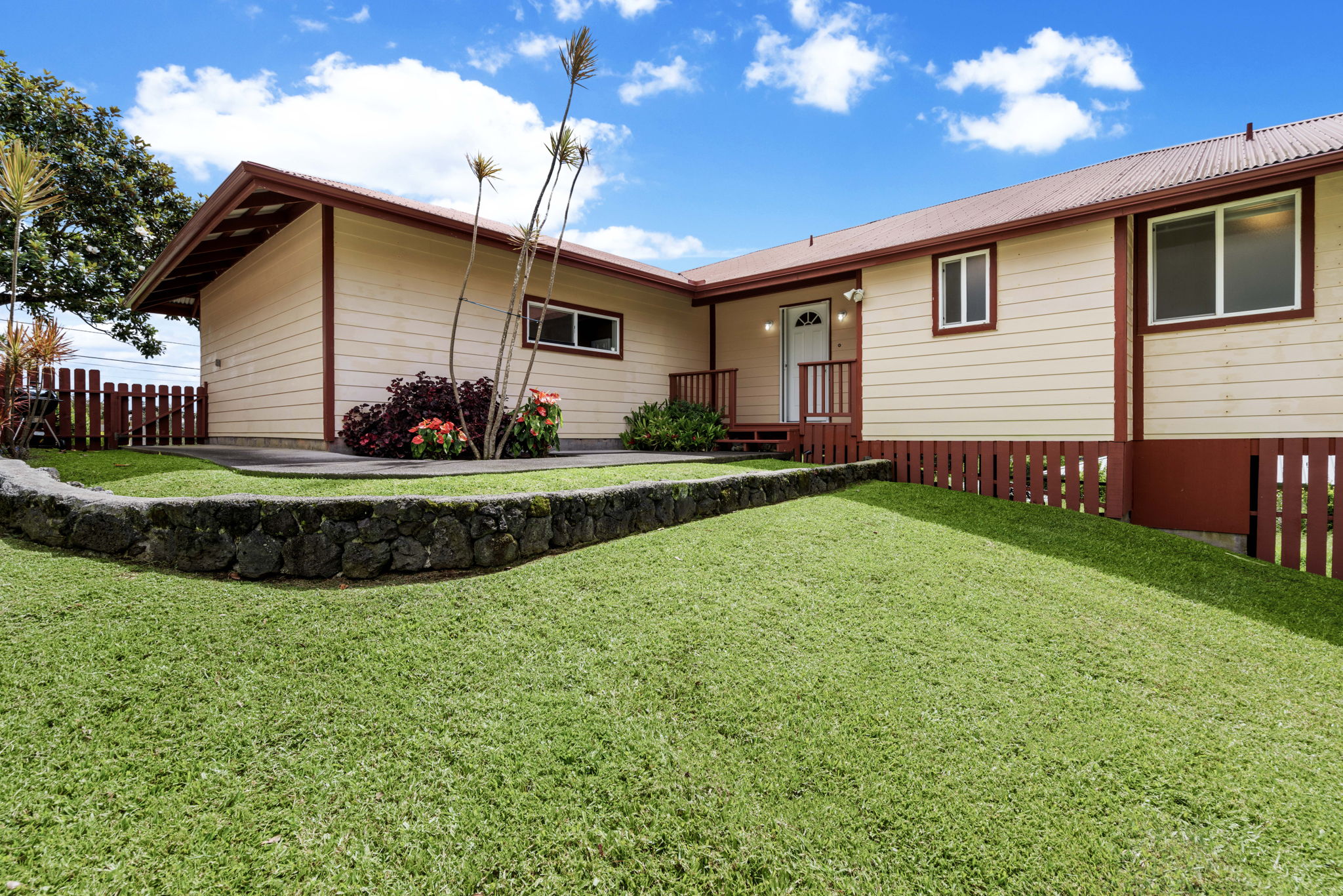 a view of a house with a yard and sitting area