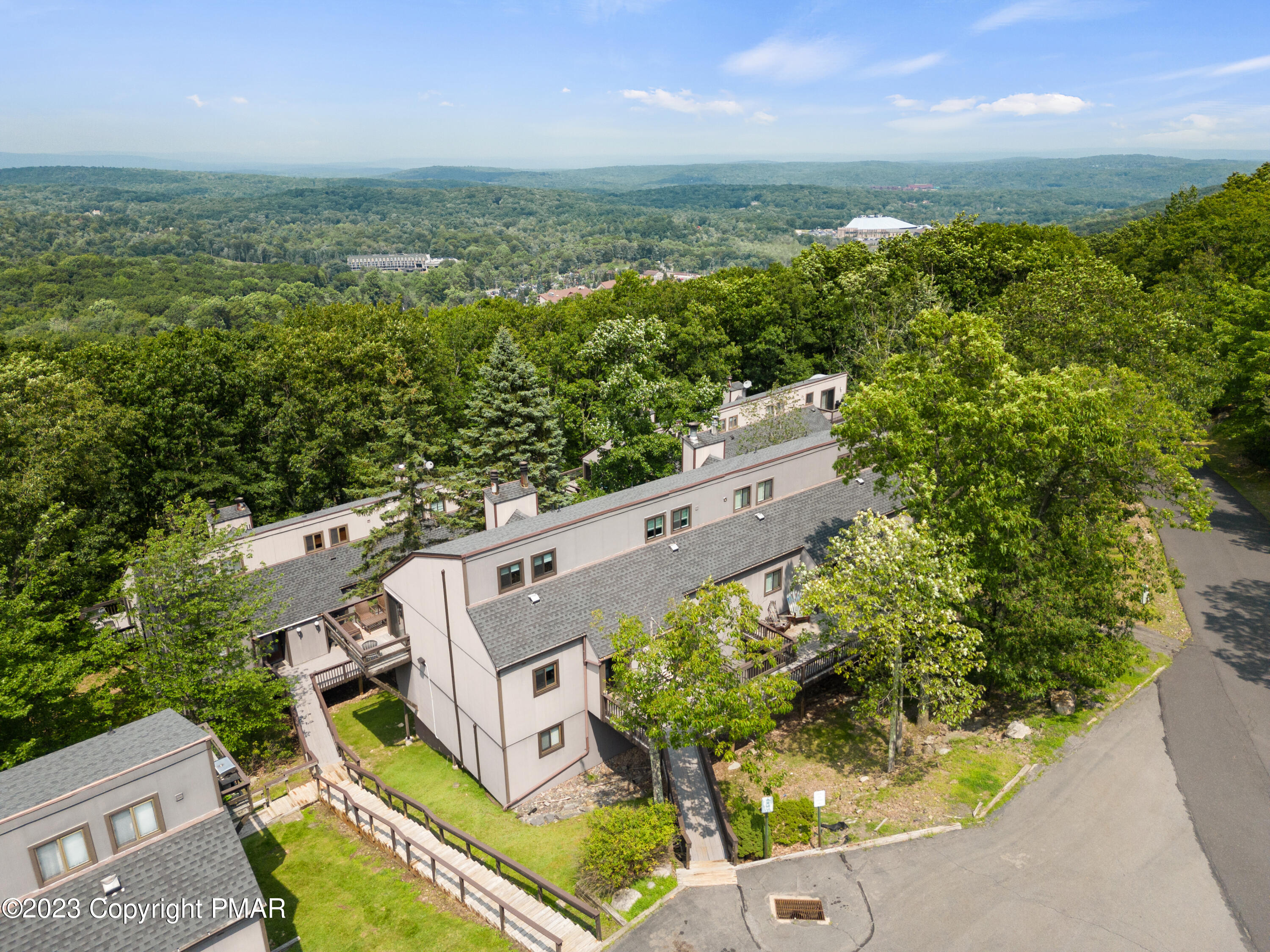 an aerial view of a house with a yard and lake view